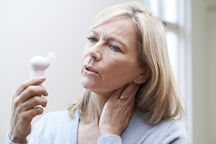 A woman experiencing hotflashes